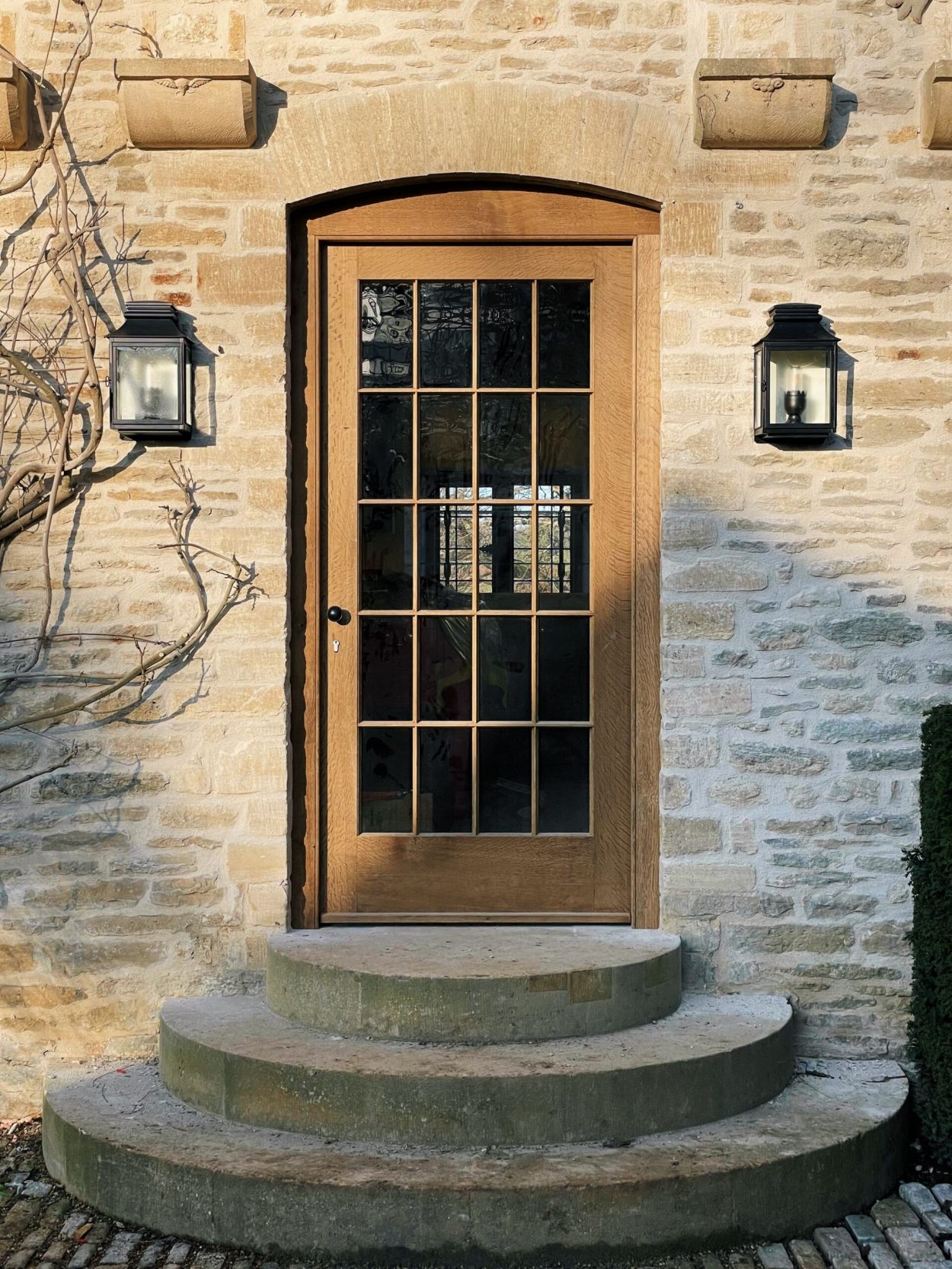 Exterior oak door of a Cotswold stone building.